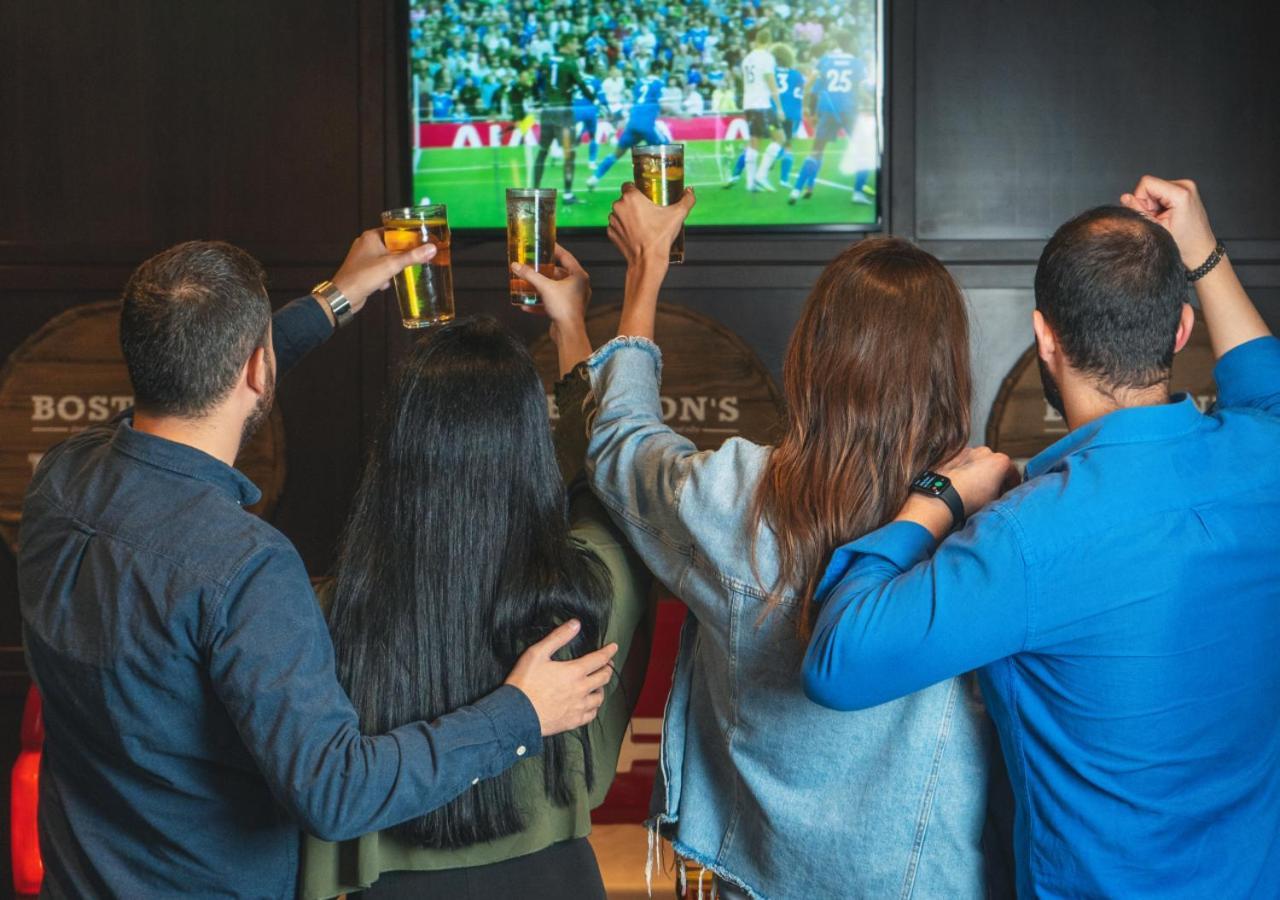 City Centre Rotana Doha Hotel Exterior photo Watching a match at a sports bar