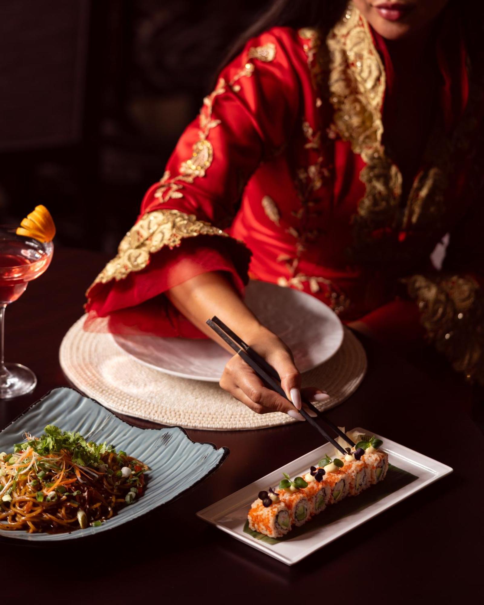 City Centre Rotana Doha Hotel Exterior photo A woman using chopsticks